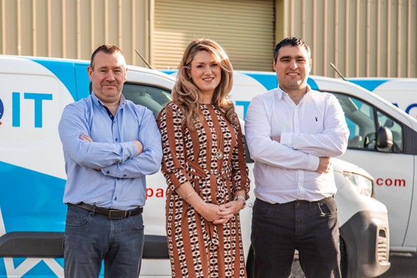 PAQ leadership team Orla - Dearann and Stephen standing in front of PAQ branded vans